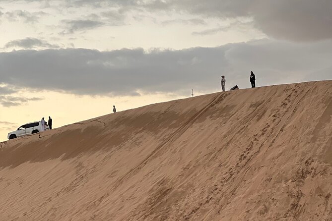 Desert Safari with Dune Bashing and Camel Ride plus Sand Boarding - A sunset photo stop worth protecting