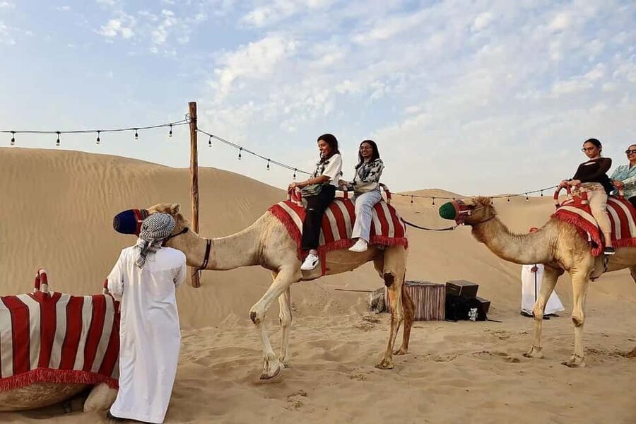 Dubai: Desert Safari, Camel Ride, Quad Bike & BBQ Dinner - Camel riding and sandboarding on the dunes