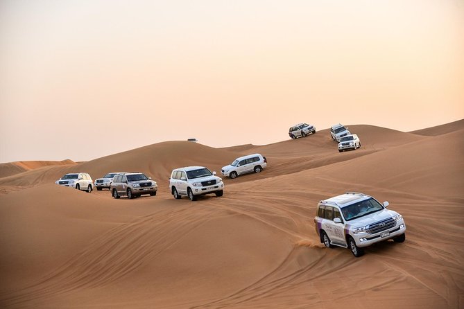 Dubai Desert Safari with BBQ And 4W Land Cruiser Dune Bashing Experience - Sunset, sandboarding, and the short camel ride