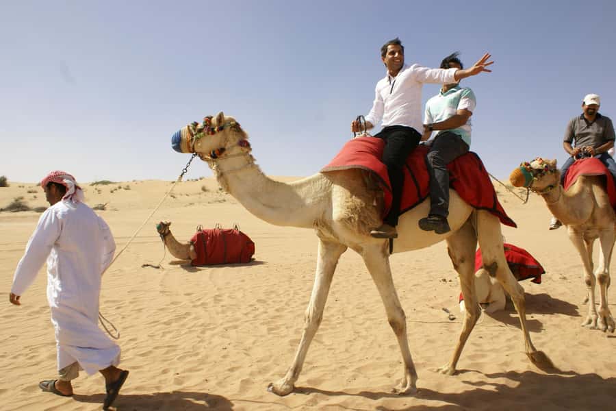 Dubai: Evening Tour with Quad Biking, Camel Ride, and BBQ - Sandboarding is fun but shorter than expected