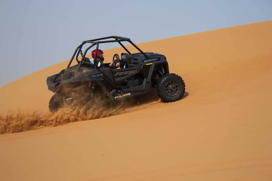 Dubai: Red Dune Desert, Dune Buggy Ride & BBQ Buffet Dinner - Sandboarding across the red dunes