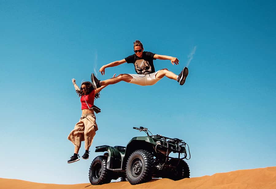 Dubai: Red Dunes Quad Bike with Sandboarding, Camels and BBQ - Sandboarding on soft desert sand