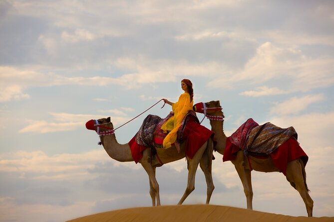 Dubai Self-drive Quad Bike, Sand Boarding, Camels & Refreshments - Riding a quad bike across the red dunes