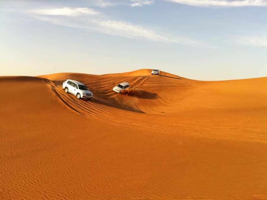 Evening Desert Dune Bashing by 4<em>4 Vehicle – Key points to know before booking’ /></p>
<ul>
<li><strong>Forty-five minutes of dune bashing:</strong> The 4×4 ride is the evening’s biggest thrill, with steep climbs, turns, and soft red dunes.</li>
<li><strong>A full camp program:</strong> Expect a short camel ride, sandboarding, henna, local snacks, tea, coffee, dinner, and traditional entertainment.</li>
<li><strong>Dinner is part of the deal:</strong> The BBQ-based buffet includes plenty of choice, with vegetarian food available.</li>
<li><strong>Transport is included:</strong> Pickup and drop-off are provided within Ras Al Khaimah, with the exact morning pickup time sent on the day.</li>
<li><strong>Extra-cost choices are limited:</strong> Photos, souvenirs, alcohol, and quad biking are not included.</li>
<li><strong>A good family option for older children:</strong> The activity has suited families with young and teenage children, but children under two are not allowed.</li>
</ul>
<h2>The evening begins with a Ras Al Khaimah pickup</h2>
<p><img width="900" height="674" decoding="async" src=