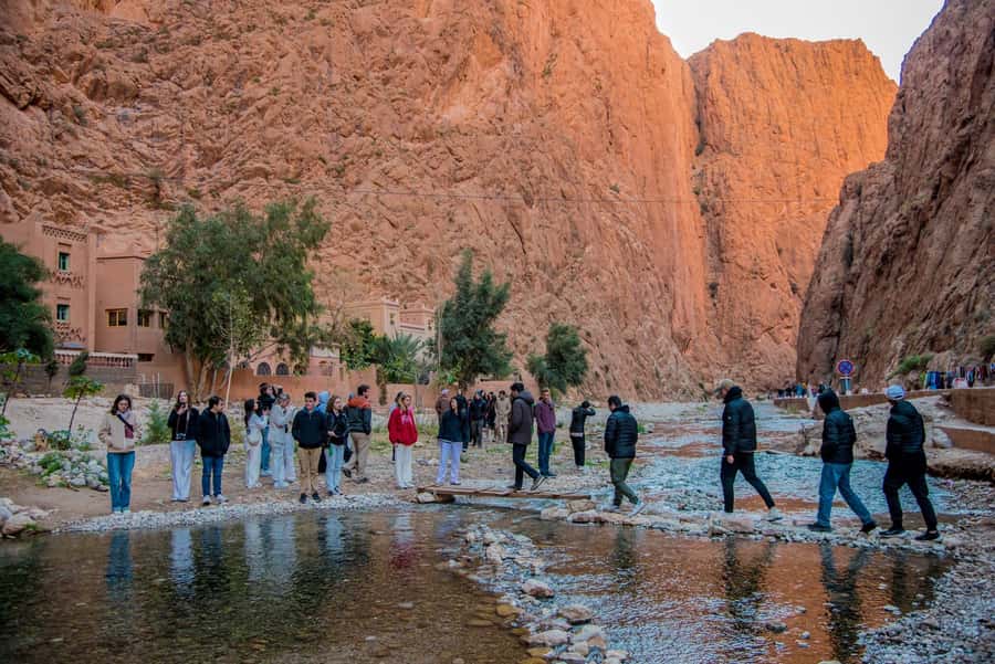 Marrakech to Fes: 3-Day Merzouga Desert Camel & Sandboarding - Walking beneath the cliffs at Todra Gorge